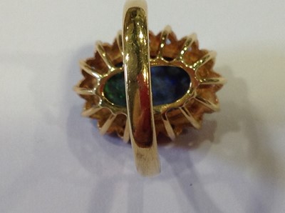 Lot 38 - A black opal and sapphire dress ring.