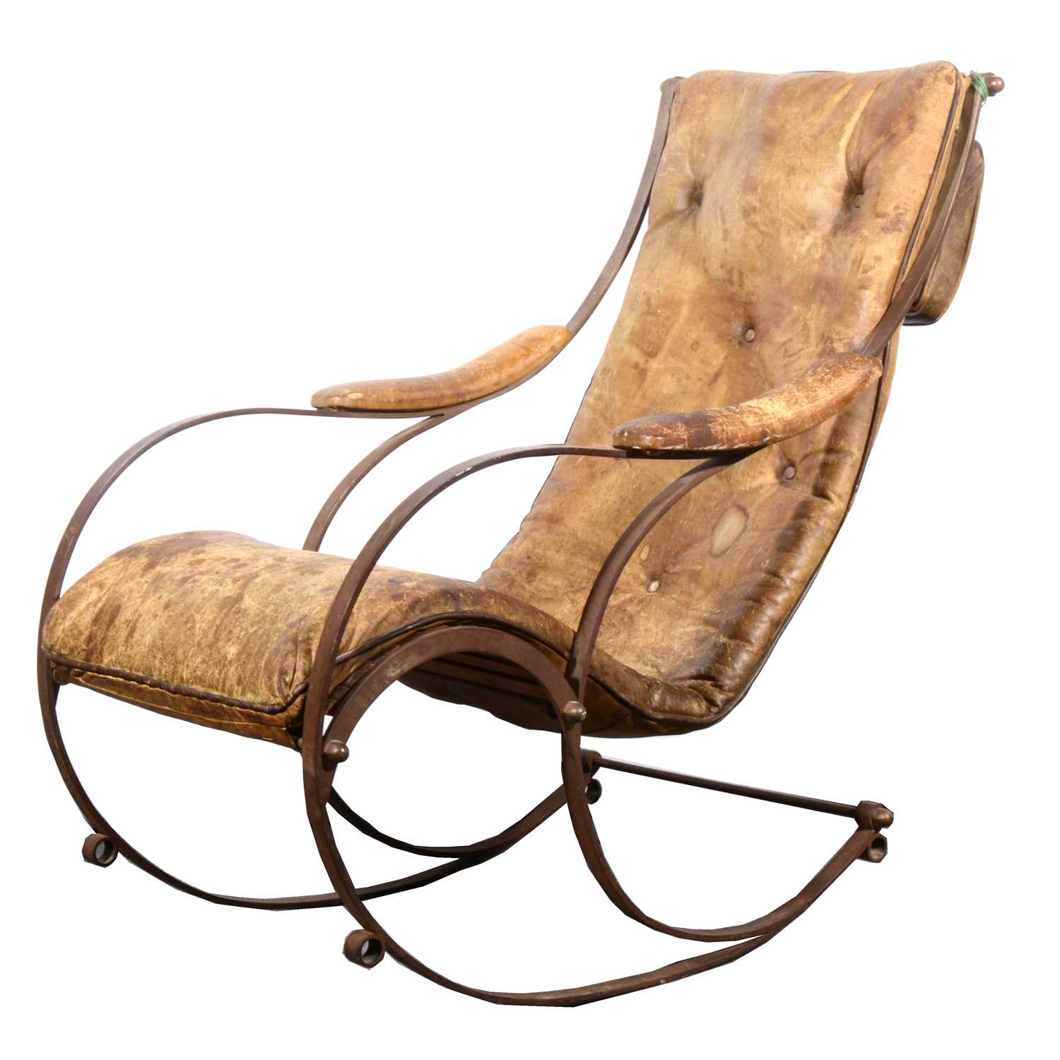 Lot 512 - A Victorian wrought iron and leather rocking chair, in the manner of R W Winfield
