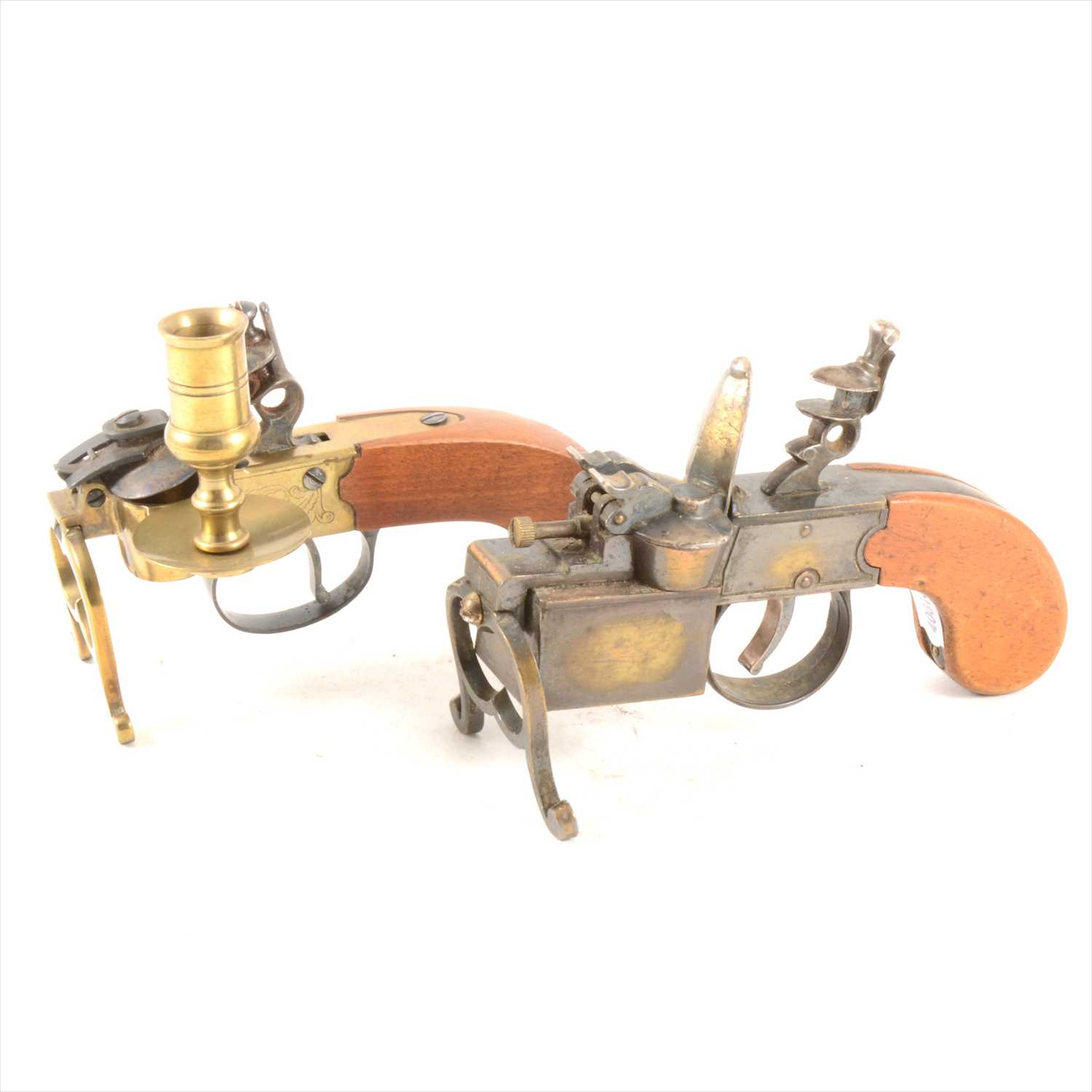 Lot 215 - A Dunhill 'Tinder Pistol' table cigarette lighter, in the shape of a boxlock Flintlock pistol, 15cm, and another similar with brass candlestic mount.