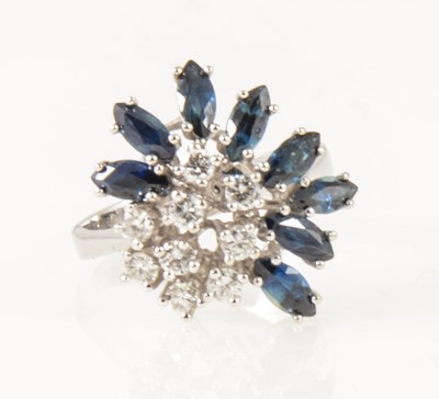 Lot 24 - A modern sapphire and diamond cluster ring.