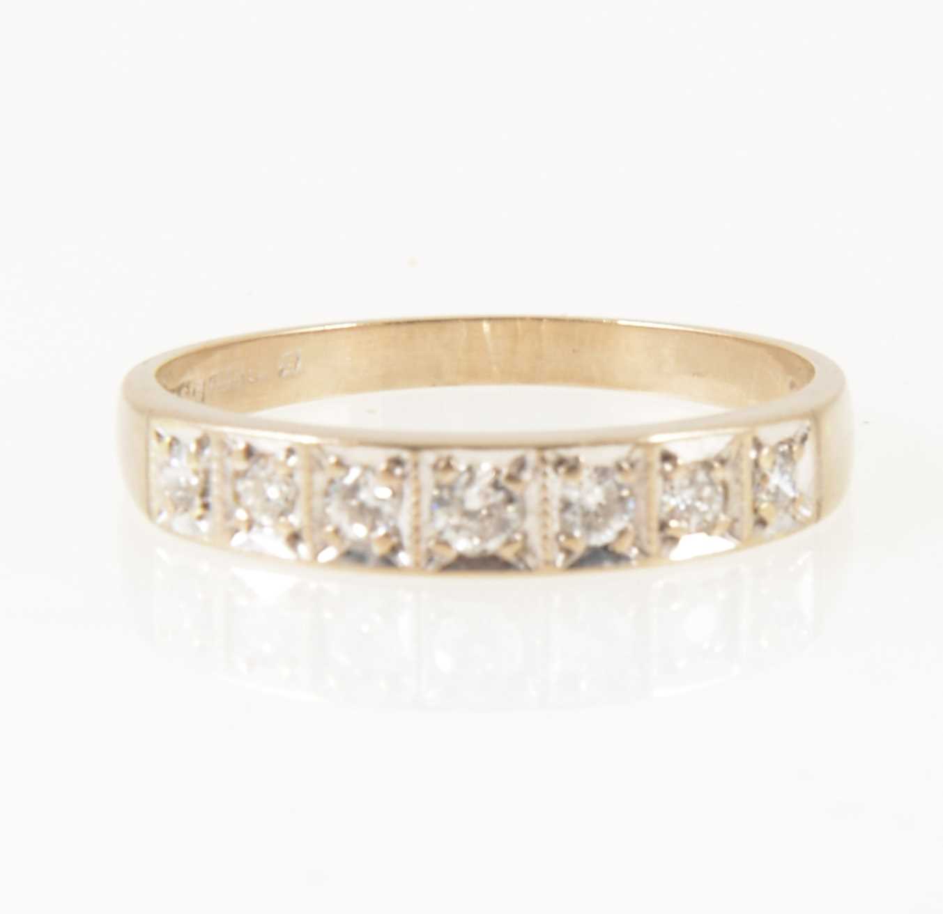 Lot 16 - A diamond half eternity ring.