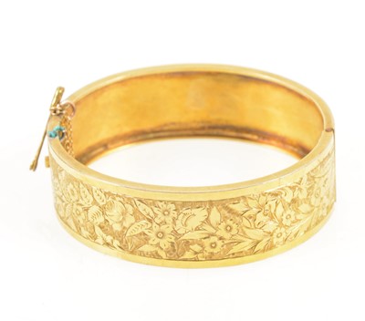 Lot 1299 - A yellow metal half hinged bangle.