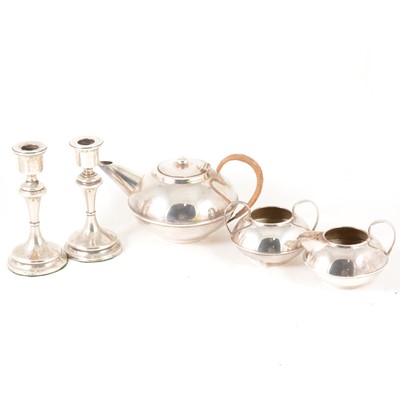 Lot 189 - A pair of silver-filled 16cm candlesticks, a silver plated three-piece teaset by Plato.