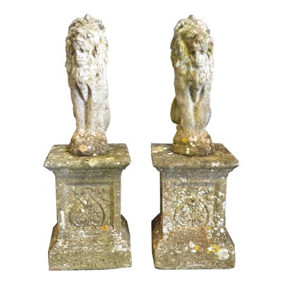 Lot 194 - A pair of concrete models of lions passant, on square plinths