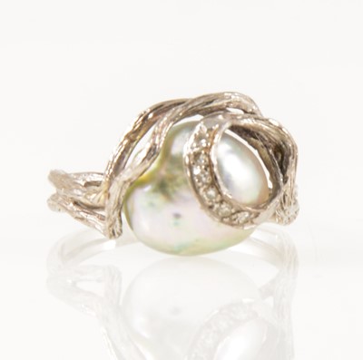 Lot 33 - A pearl and diamond dress ring.