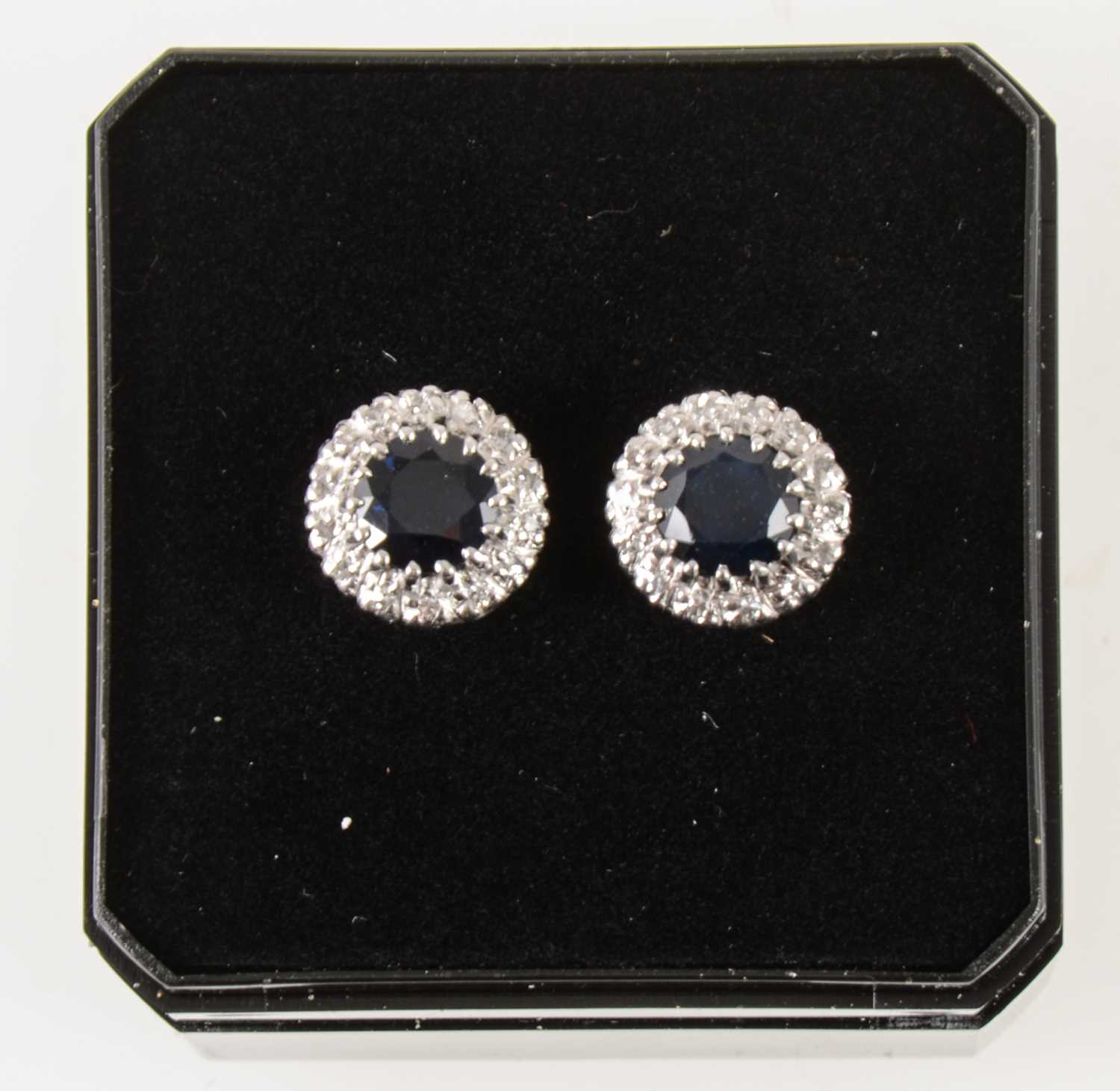 Lot 54 - A pair of sapphire and diamond earstuds