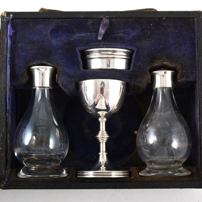 Lot 176 - Two travelling communion sets, one silver, the other plated, and another paten and chalice.