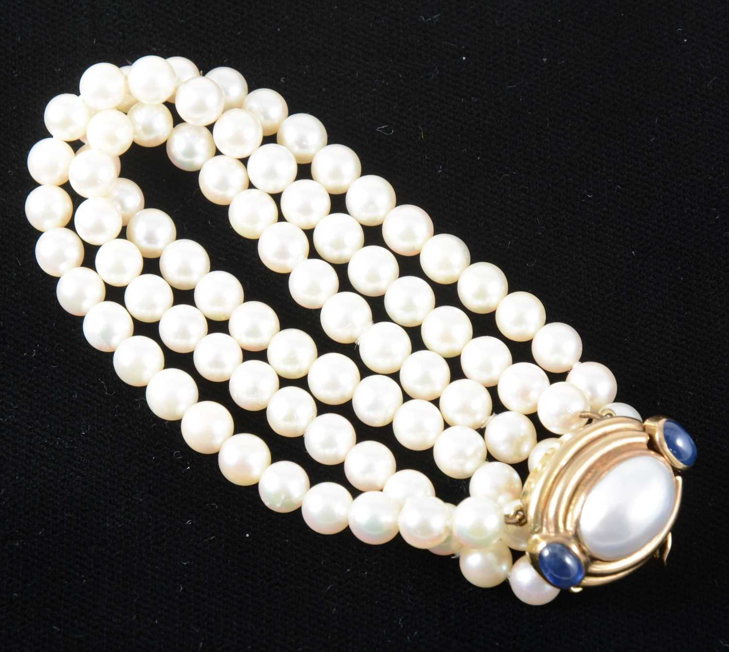 Lot 132 - A three row cultured pearl bracelet.