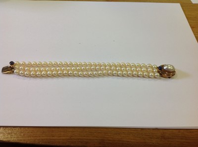 Lot 132 - A three row cultured pearl bracelet.