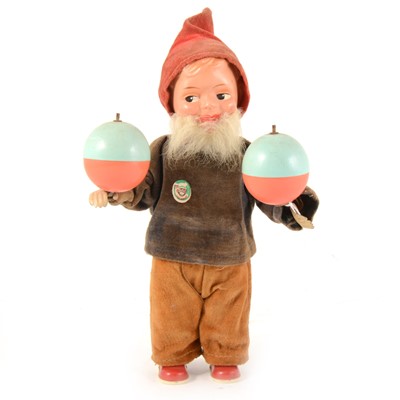 Lot 175 - A West German clock-work wind-up gnome, felt outfit, tin-plate and plastic construction, with two moving balls on arms, 22cm tall.