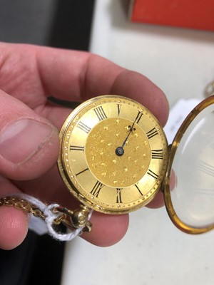 Lot 193 - A small 18 carat yellow gold open face pocket watch and neck chain.