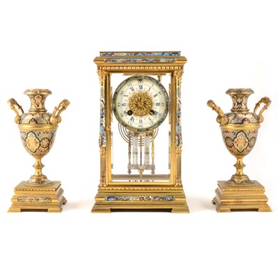 Lot 391 - A French gilt metal and champleve enamel clock garniture