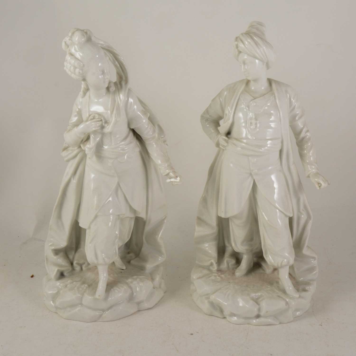 Lot 1012 - A pair of Continental porcelain figures of a courtesan and Ottoman fighter