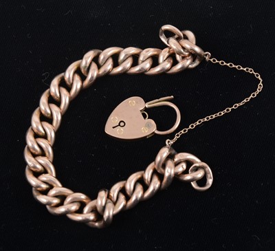 Lot 1307 - A yellow metal hollow curb link chain, marked 9ct, with 9ct gold padlock clasp.