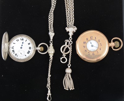 Lot 1374 - A Waltham gold plated half hunter pocket watch, a silver half hunter pocket watch and two white metal fancy watch chains