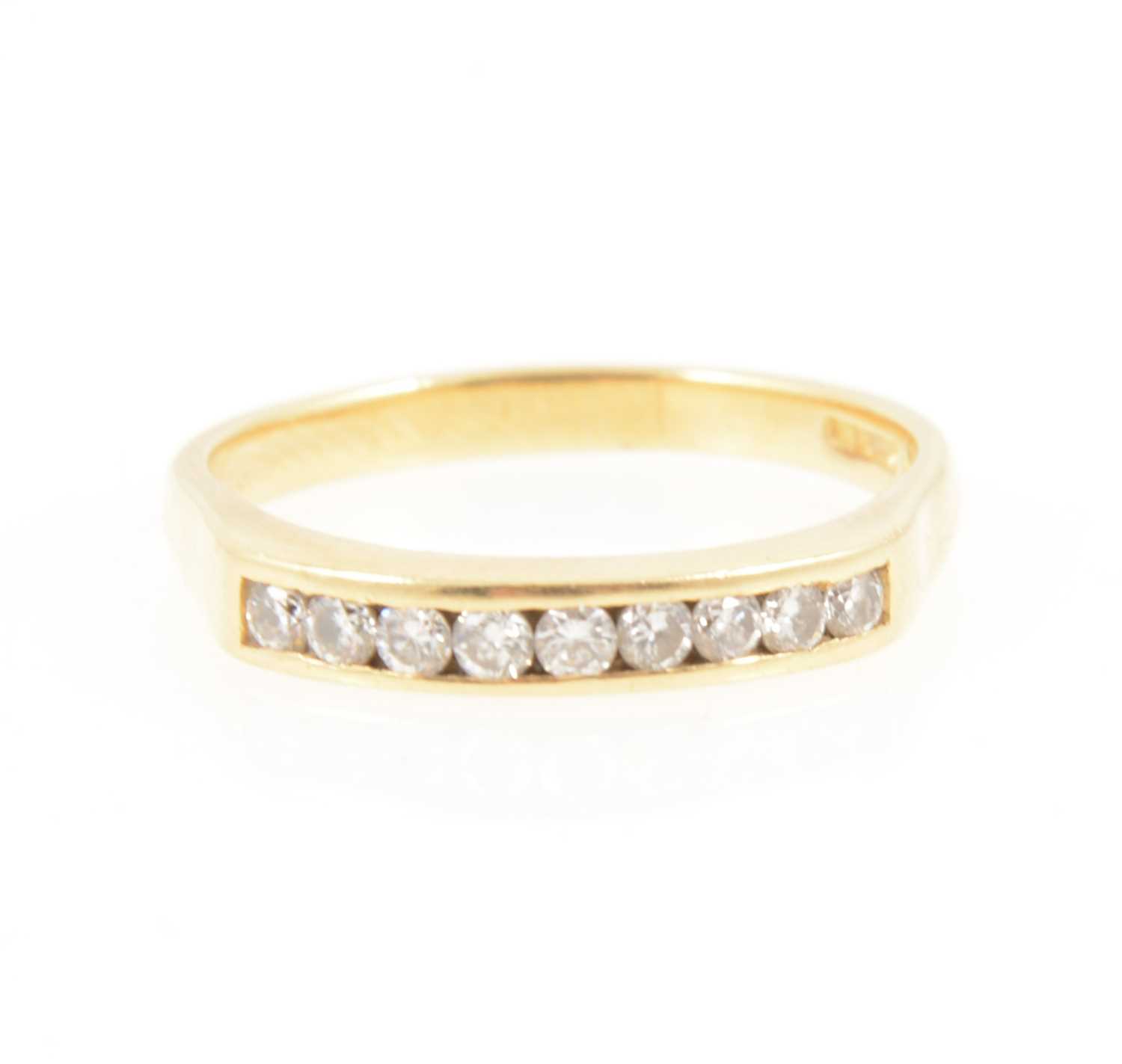 Lot 1252 - A diamond half hoop ring.