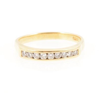 Lot 1252 - A diamond half hoop ring.