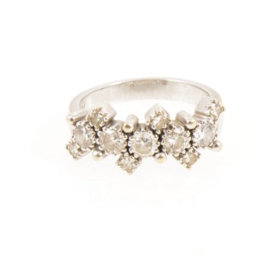 Lot 350 - A diamond half hoop ring, five major diamonds and six smaller diamonds.