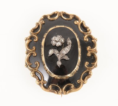 Lot 1288 - A Victorian mourning brooch set with a diamond flower motif, hair locket back.