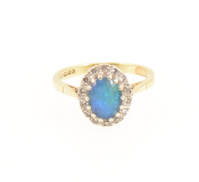 Lot 1267 - An opal triplet oval cluster ring.