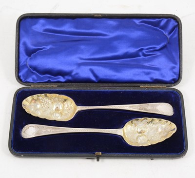 Lot 1182 - A cased set of George III  silver berry spoons with later engraving.