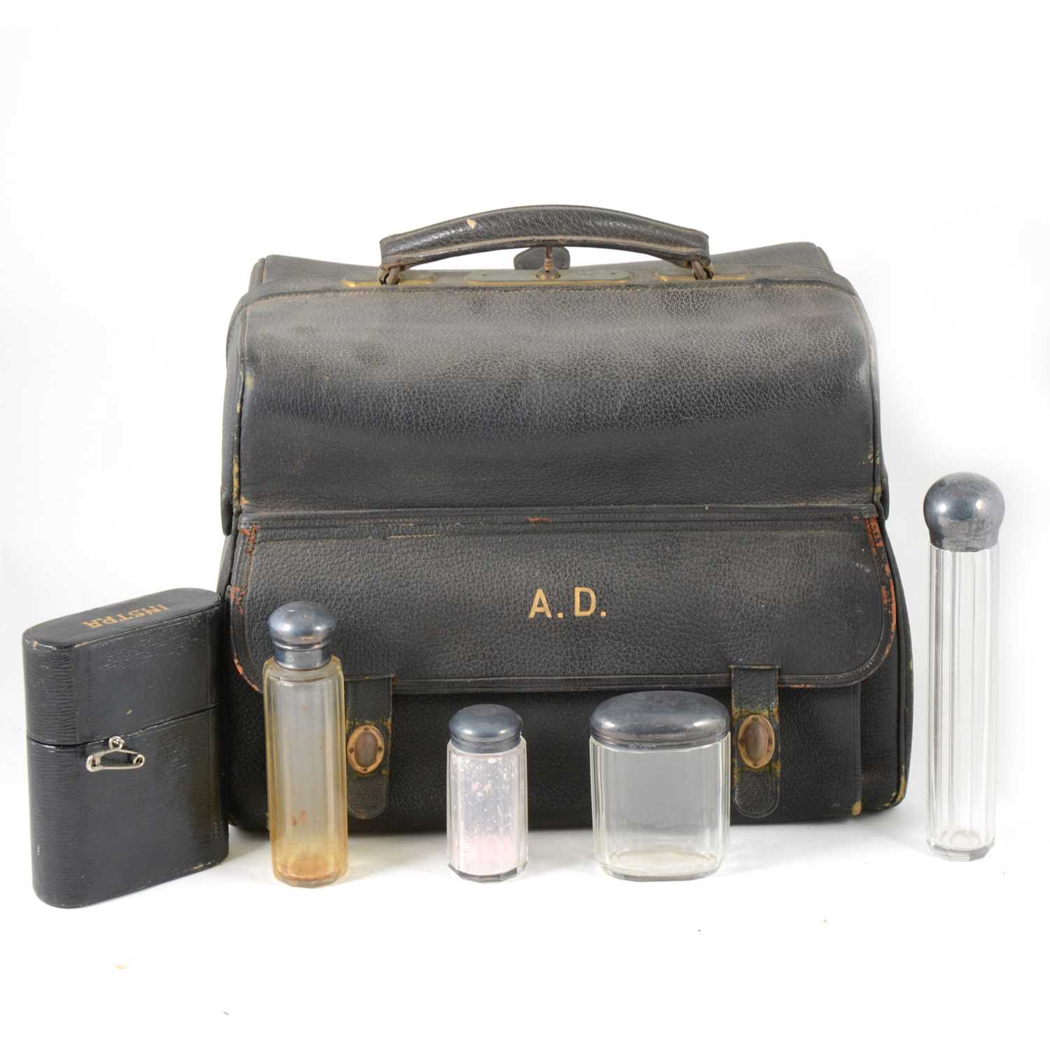 Lot 114 - Leather travelling bag with part fitted silver-mounted glass bottle set