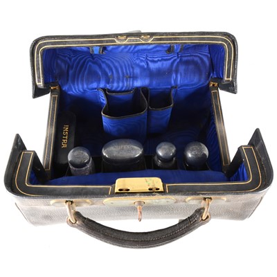 Lot 114 - Leather travelling bag with part fitted silver-mounted glass bottle set