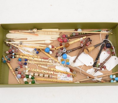 Lot 1161 - A collection of bone and wooden pillow lace bobbins, hooks etc.