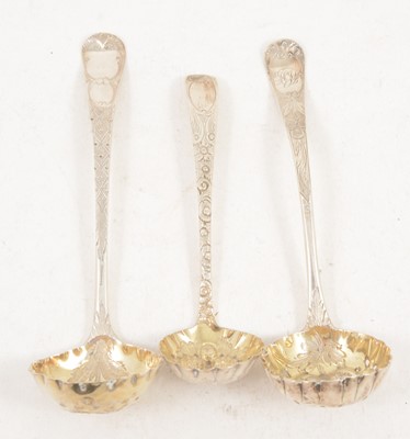 Lot 1207 - Three silver sugar sifting spoons with gilded berry bowls.