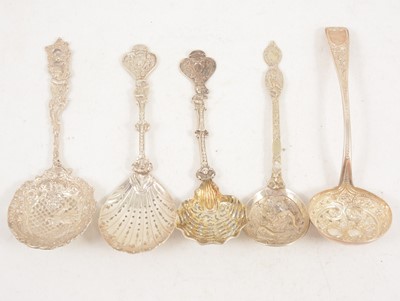 Lot 1200 - Five large ornate silver sugar sifting spoons.