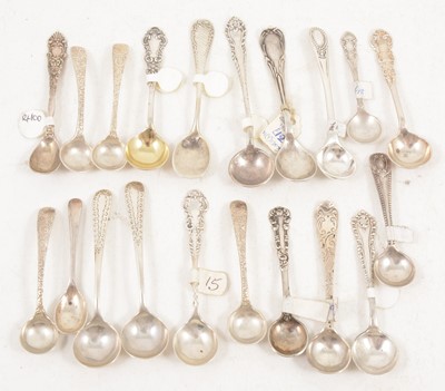 Lot 1196 - Nineteen decorative silver and white metal salt spoons.
