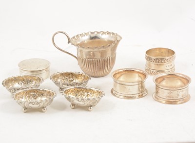 Lot 1219 - A Victorian silver cup, three napkin rings, four salts and trinket pot.