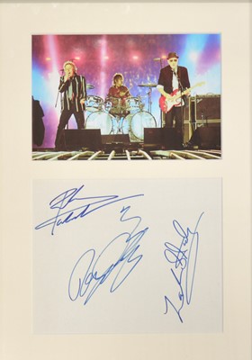 Lot 306 - The Who; three signatures, Pete Townsend, Roger Daltrey, Zak Starksy, mounted, framed and glazed with photo above, 38cm by 25cm.