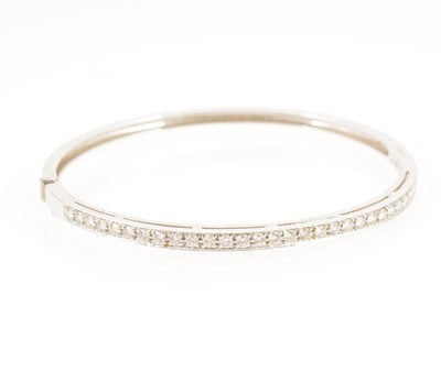 Lot 1297 - A modern diamond set half hinged bangle