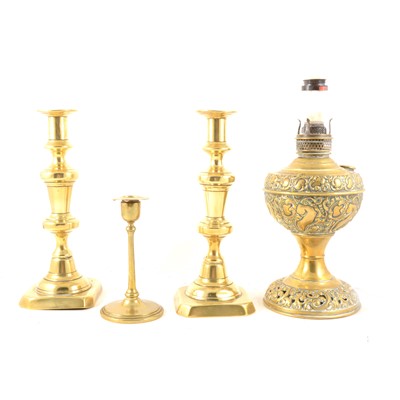 Lot 131 - Brass candlesticks, a brass oil lamp converted to electricity, and four modern lamps.