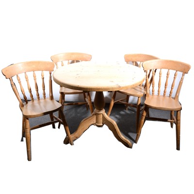 Lot 570 - A circular pine kitchen table and four chairs