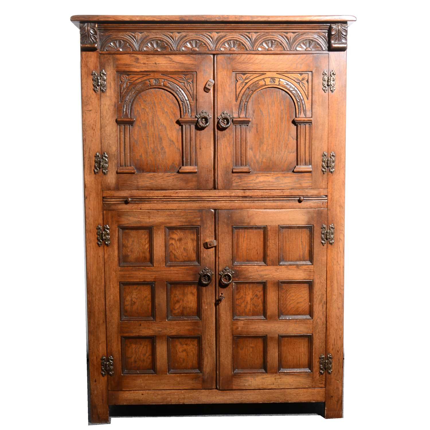 Lot 519 - An oak cocktail cabinet