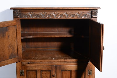 Lot 519 - An oak cocktail cabinet