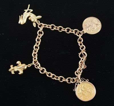 Lot 360 - A 9 carat yellow gold bracelet with three charms and a Half Sovereign