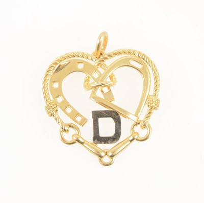 Lot 1245 - A yellow metal heart shape pendant with equestrian detail.