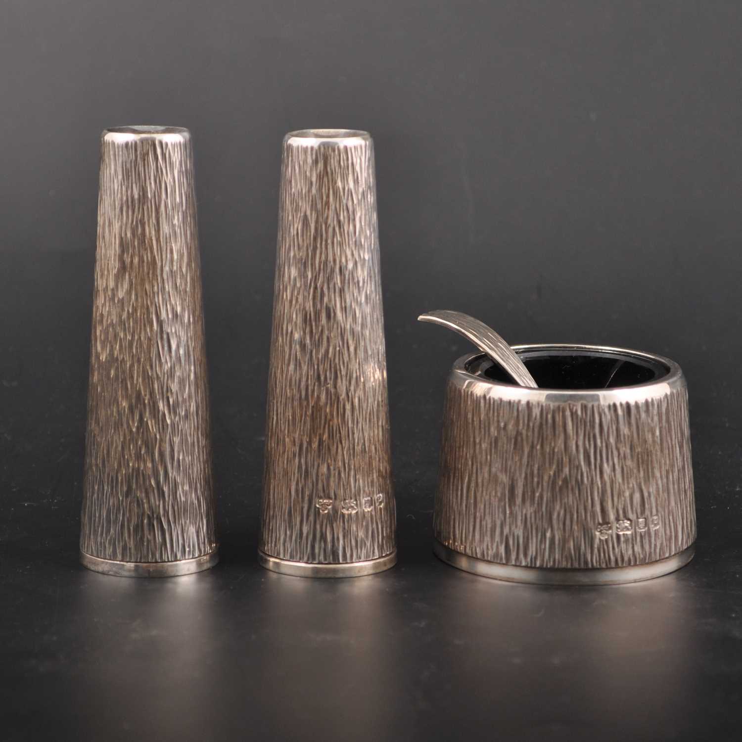 Lot 640 - A textured silver three-piece silver condiment set, by C. J. Vander Limited, London 1970
