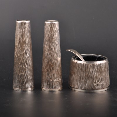 Lot 640 - A textured silver three-piece silver condiment set, by C. J. Vander Limited, London 1970