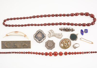 Lot 1333 - Two cherry amber coloured bead necklaces, paste clip and mother-of-pearl crescent moon brooch.