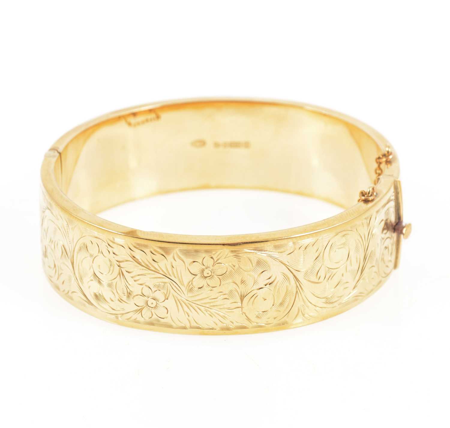 Lot 1298 - A 9 carat yellow gold half hinged bangle.