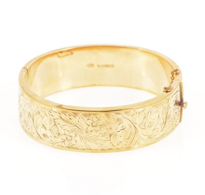 Lot 1298 - A 9 carat yellow gold half hinged bangle.