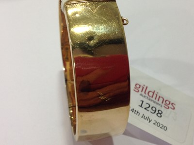 Lot 1298 - A 9 carat yellow gold half hinged bangle.