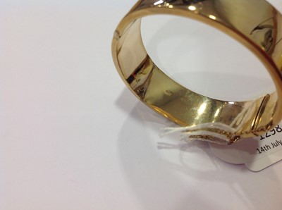 Lot 1298 - A 9 carat yellow gold half hinged bangle.