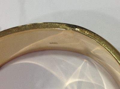 Lot 1298 - A 9 carat yellow gold half hinged bangle.