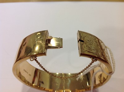 Lot 1298 - A 9 carat yellow gold half hinged bangle.