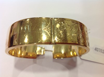 Lot 1298 - A 9 carat yellow gold half hinged bangle.